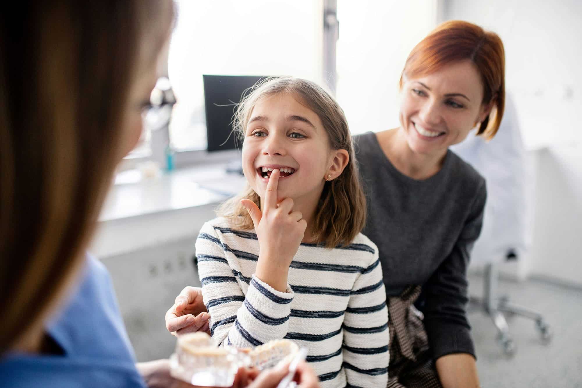 A friendly administrative team member organizing schedules at our modern pediatric clinic to help you find a top-tier Lexington kids dentist