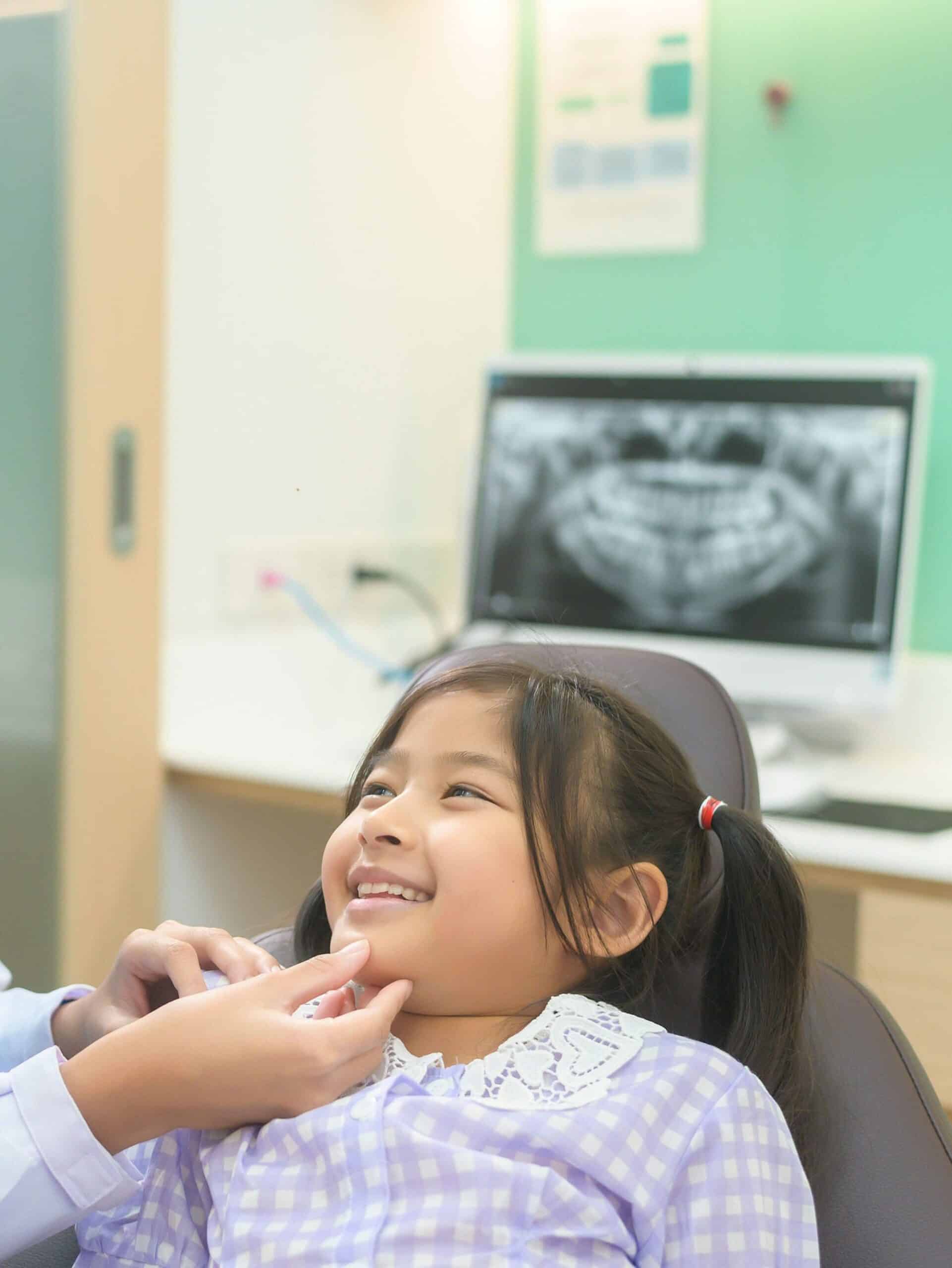 A local South Carolina child smiling during a quick session for safe pediatric dental x-rays at Sunset Children's Dentistry