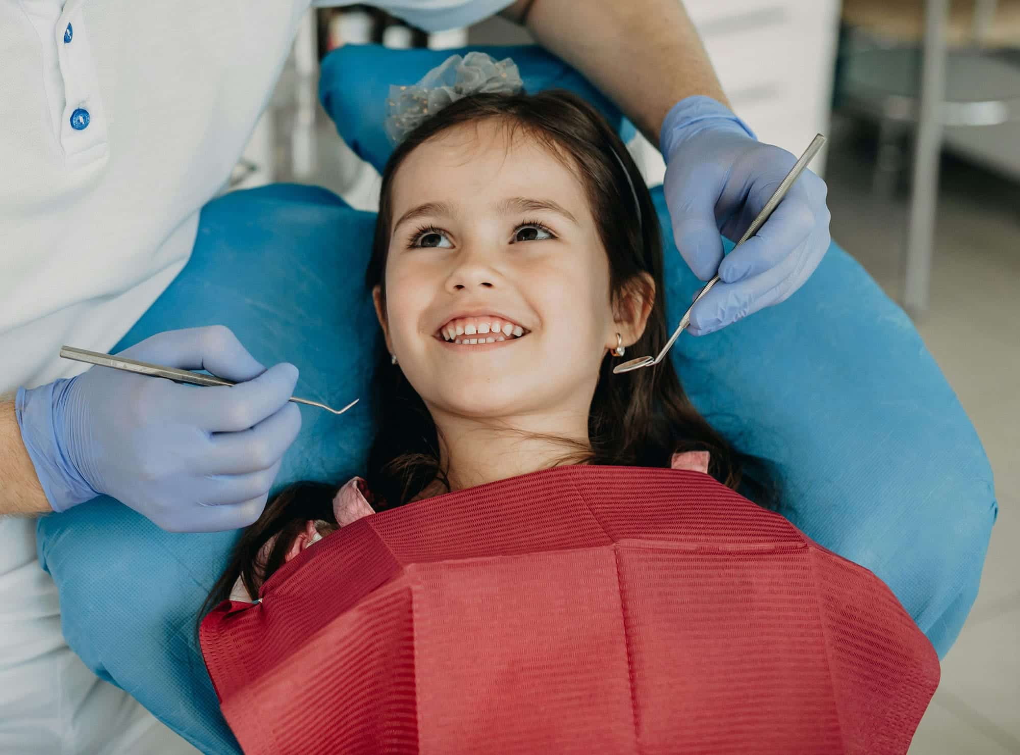 A compassionate pediatric dentist treating tooth decay in children gently at Sunset Children's Dentistry