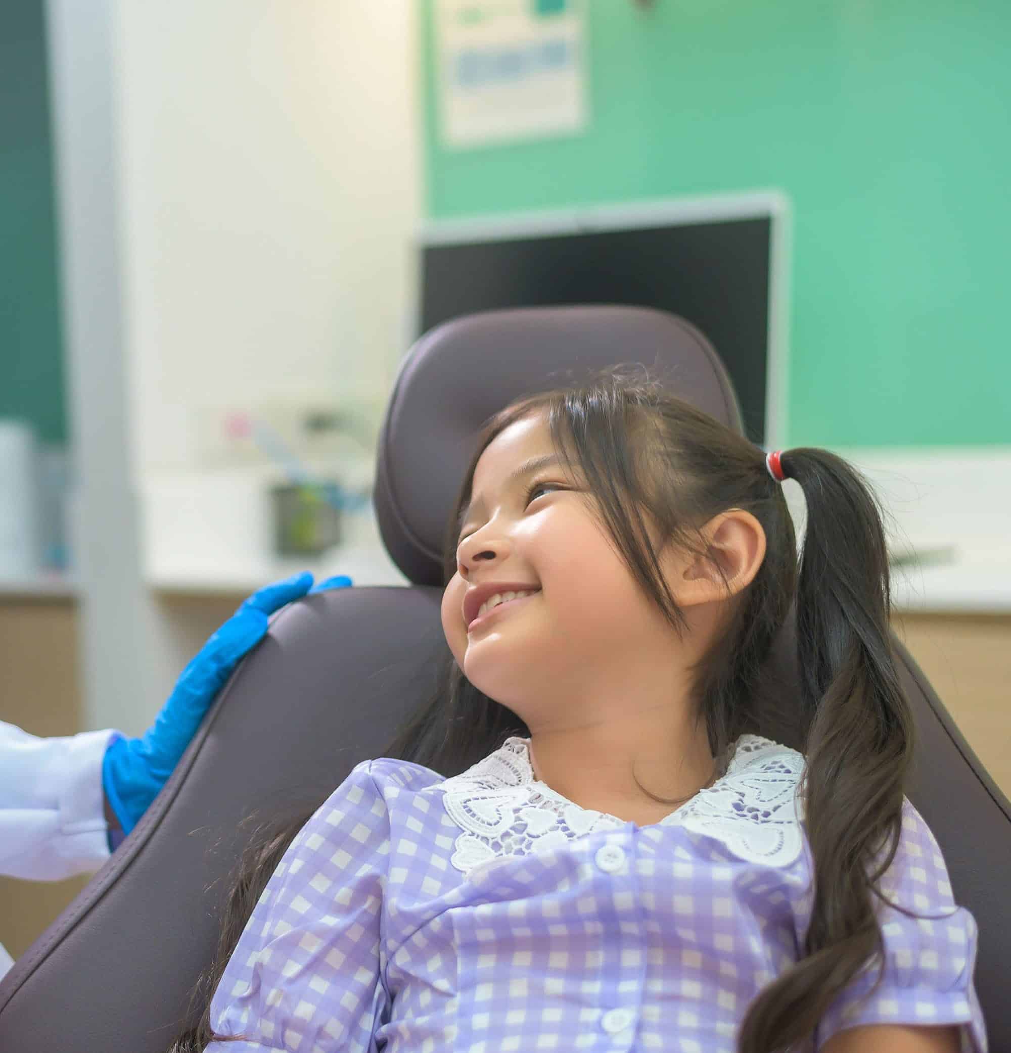 Smiling child learning about kids dental health with a children's dentist in Lexington, SC